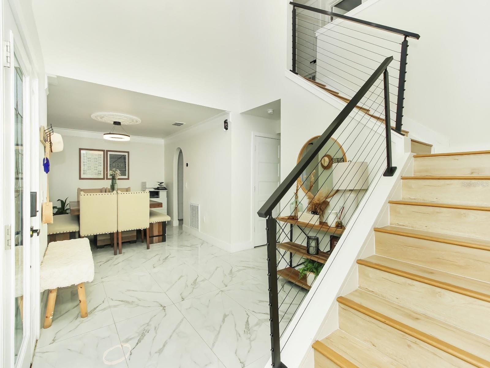 The stairs are decorated with a steel banister giving you a modern touch to the design - 7561 LAKE ANDREA CIR, MOUNT DORA