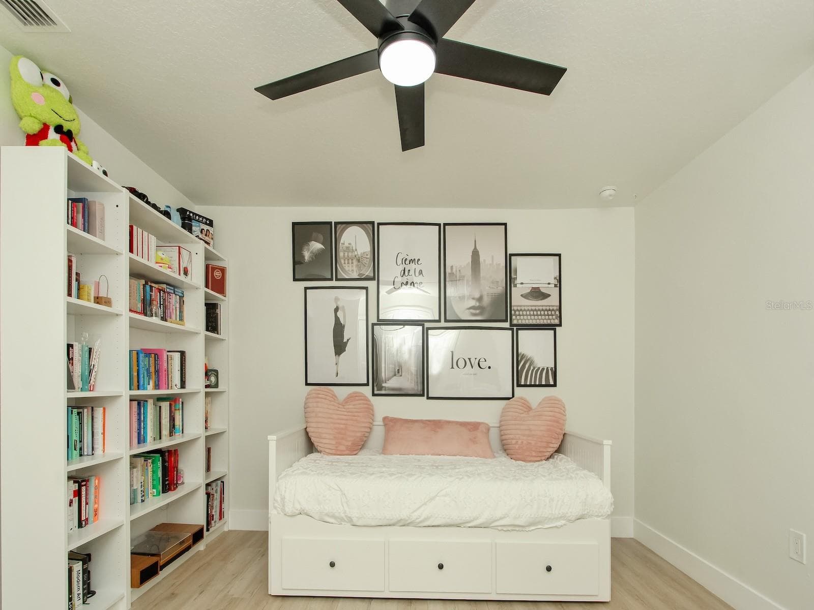 1 of 5 bedrooms this is the quest quarters which sports a library and a remote control fan - 7561 LAKE ANDREA CIR, MOUNT DORA