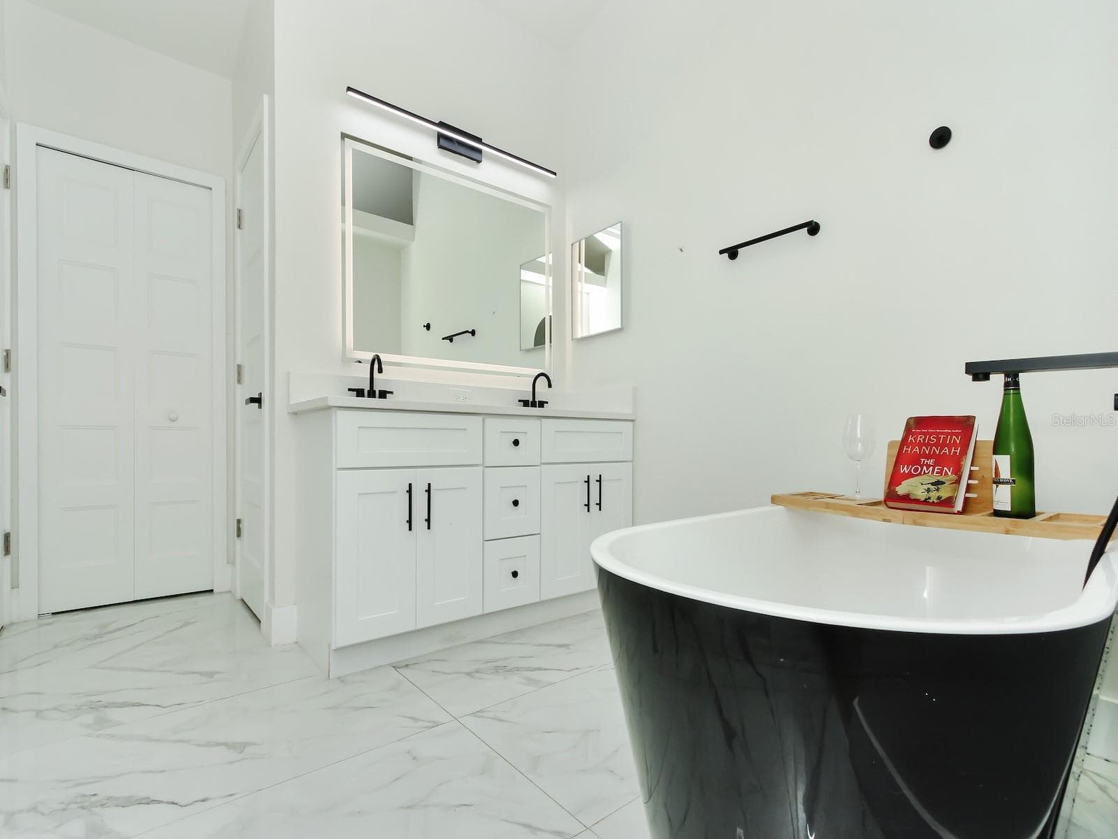 The master quarters bathroom come complete with shower, his and her sinks alongside a garden tub. - 7561 LAKE ANDREA CIR, MOUNT DORA