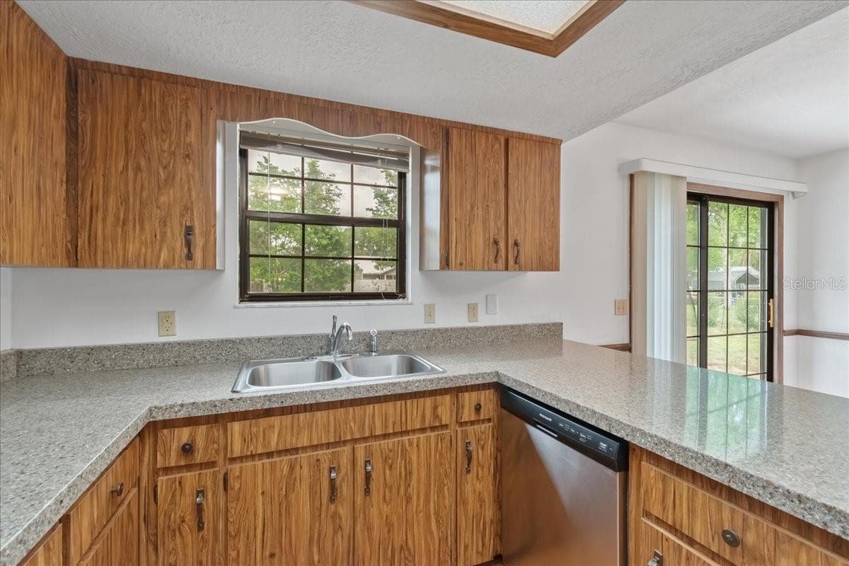 Kitchen Window Overlooks Backyard and New Dishwasher - 4515 SE 59TH ST, OCALA