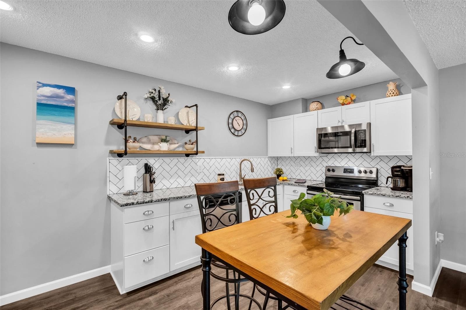Granite countertops, recessed lighting, and sleek stainless appliances~ - 2642 PINE RIDGE WAY S #G2, PALM HARBOR