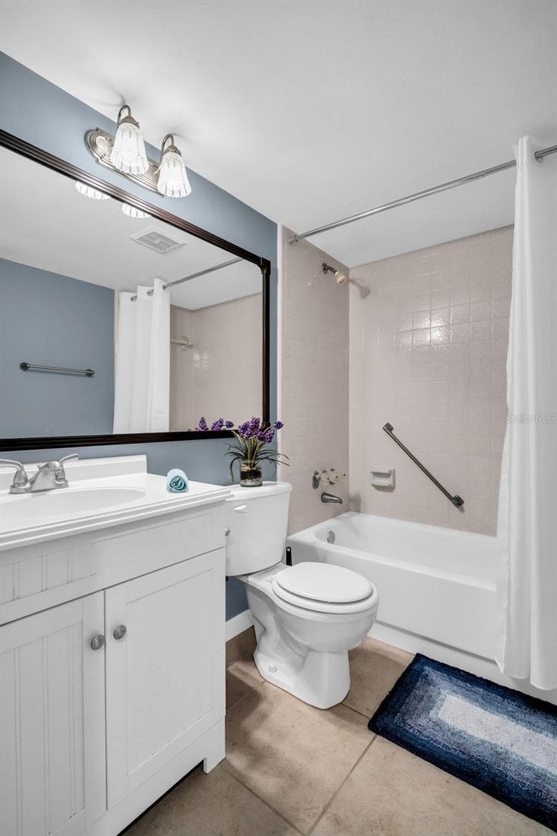 Beautiful hall bath with newer vanity, tub/shower combo, and perfectly located adjacent from the 2nd bedroom~ - 2642 PINE RIDGE WAY S #G2, PALM HARBOR
