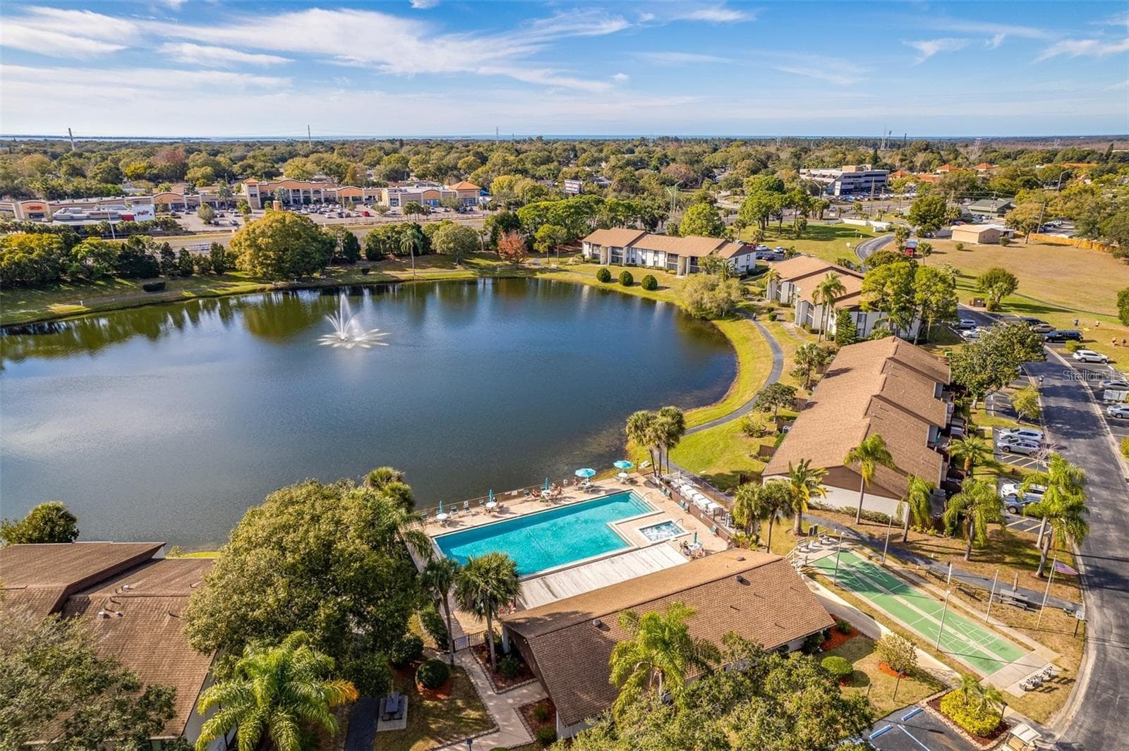 Community pool, pond, clubhouse, and shuffleboard~ - 2642 PINE RIDGE WAY S #G2, PALM HARBOR