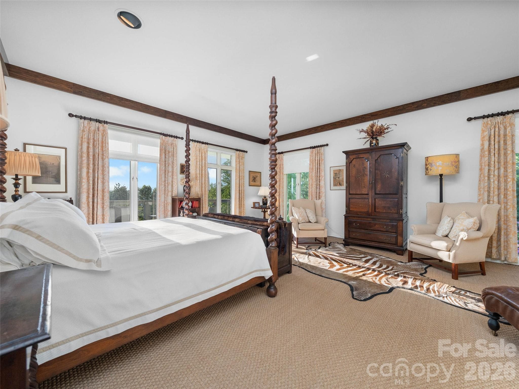 Windows surround the bedroom, welcoming mountain light from every direction. - Asheville
