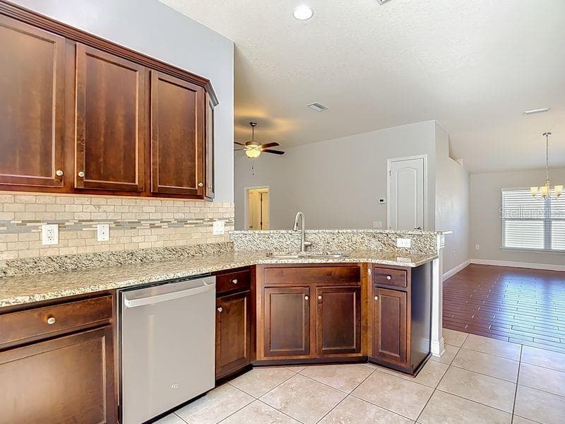 The open design flows seamlessly into the dining and living rooms - 12244 LOOPBACK DR, SAN ANTONIO