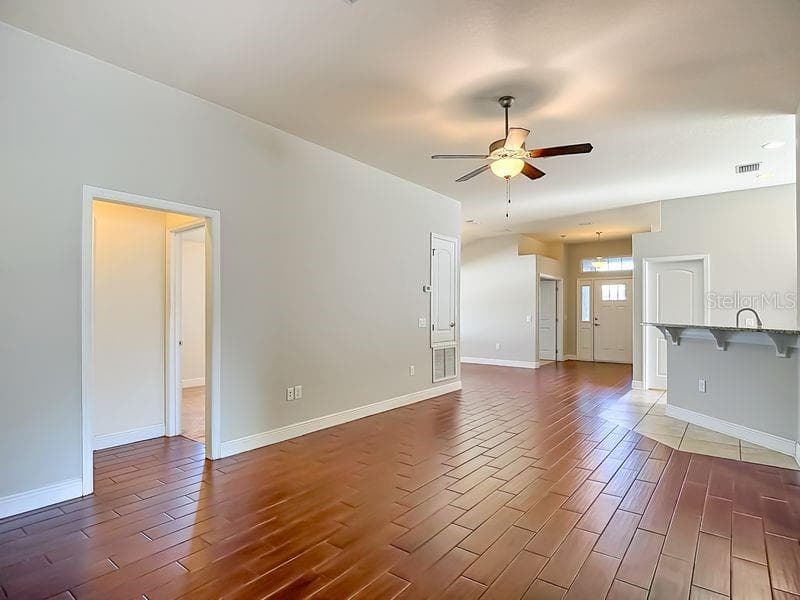 Living room looking back towards foyer, dining room, and kitchen - 12244 LOOPBACK DR, SAN ANTONIO