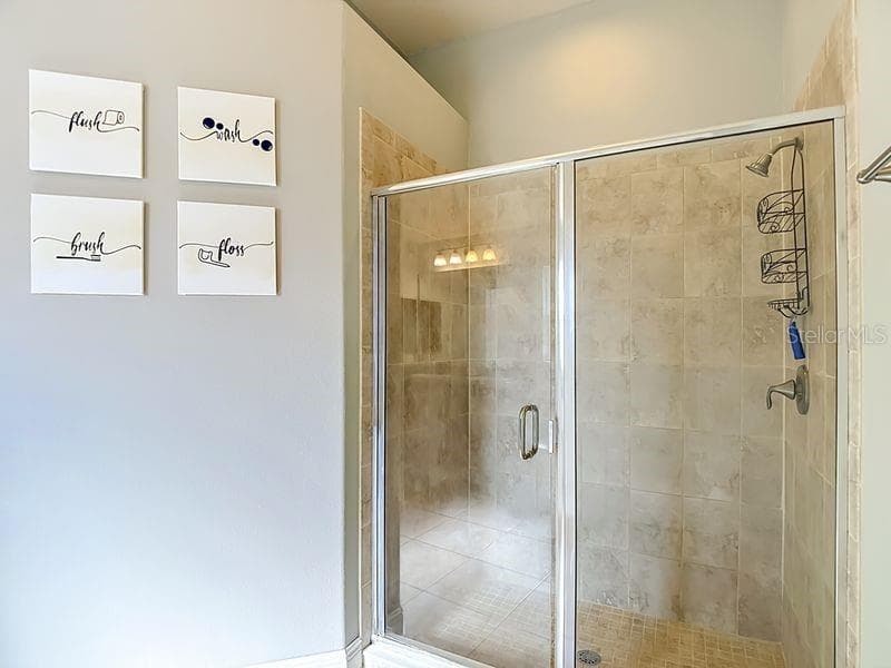 Primary bath has a spacious walk-in shower enclosed in glass - 12244 LOOPBACK DR, SAN ANTONIO