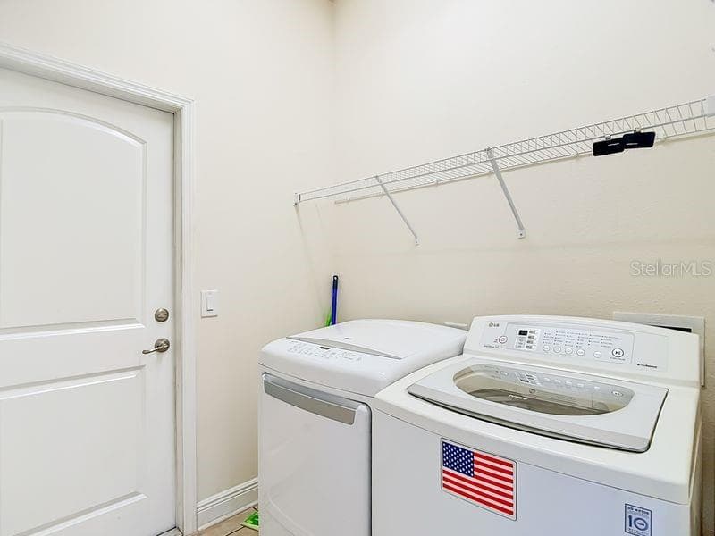Convenient laundry room located just off kitchen- this space also offers easy access to garage for added functionality - 12244 LOOPBACK DR, SAN ANTONIO