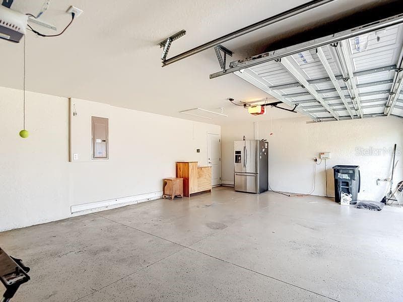 Three car garage offering ample room for vehicles, storage, or a workshop setup - 12244 LOOPBACK DR, SAN ANTONIO