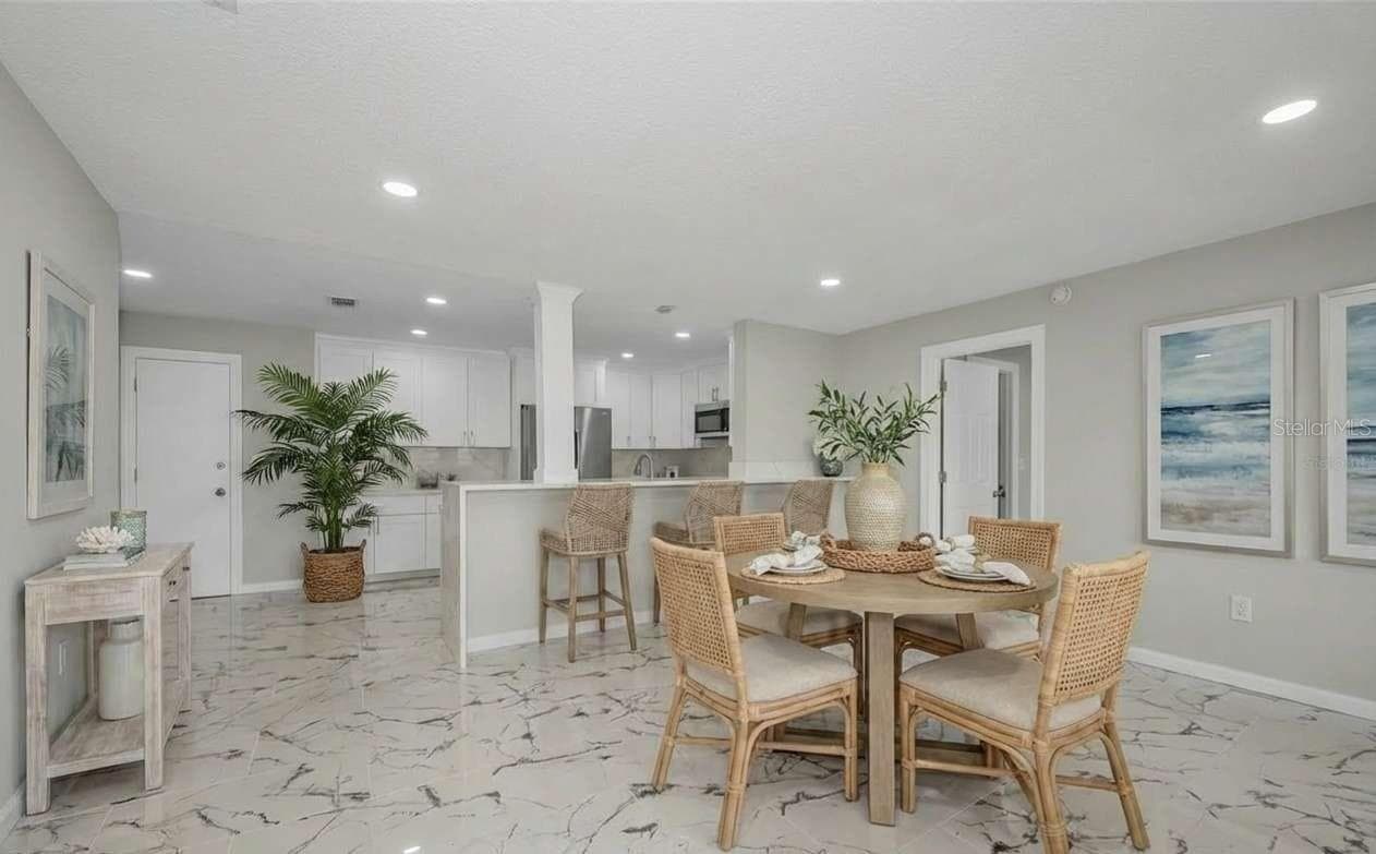 Virtual staged dining room - 100 BLUFF VIEW DR #604C, BELLEAIR BLUFFS
