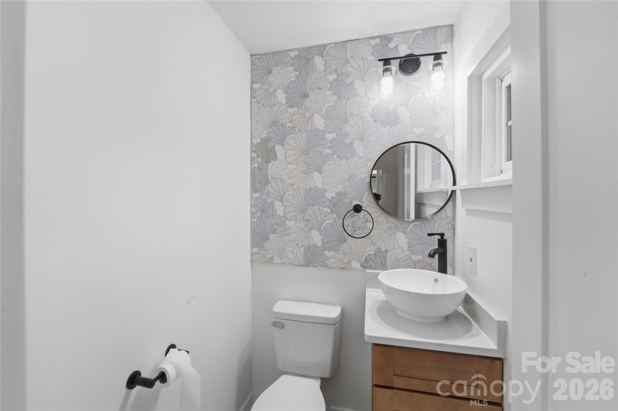 Beautifully done half bath with ceramic tile wall detail. - 4314 Ivanhoe Place, Charlotte