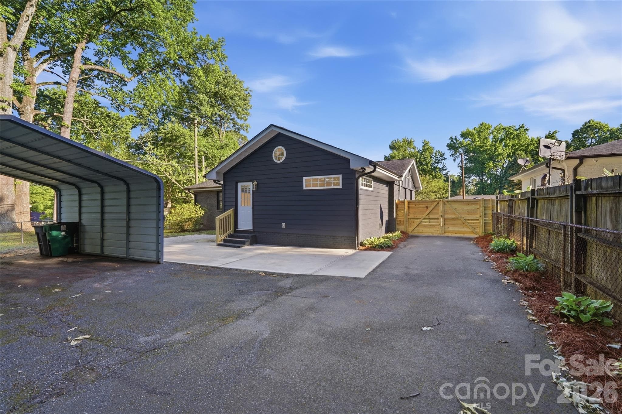 Fully paved driveway facilitates private parking under carport. - 4314 Ivanhoe Place, Charlotte