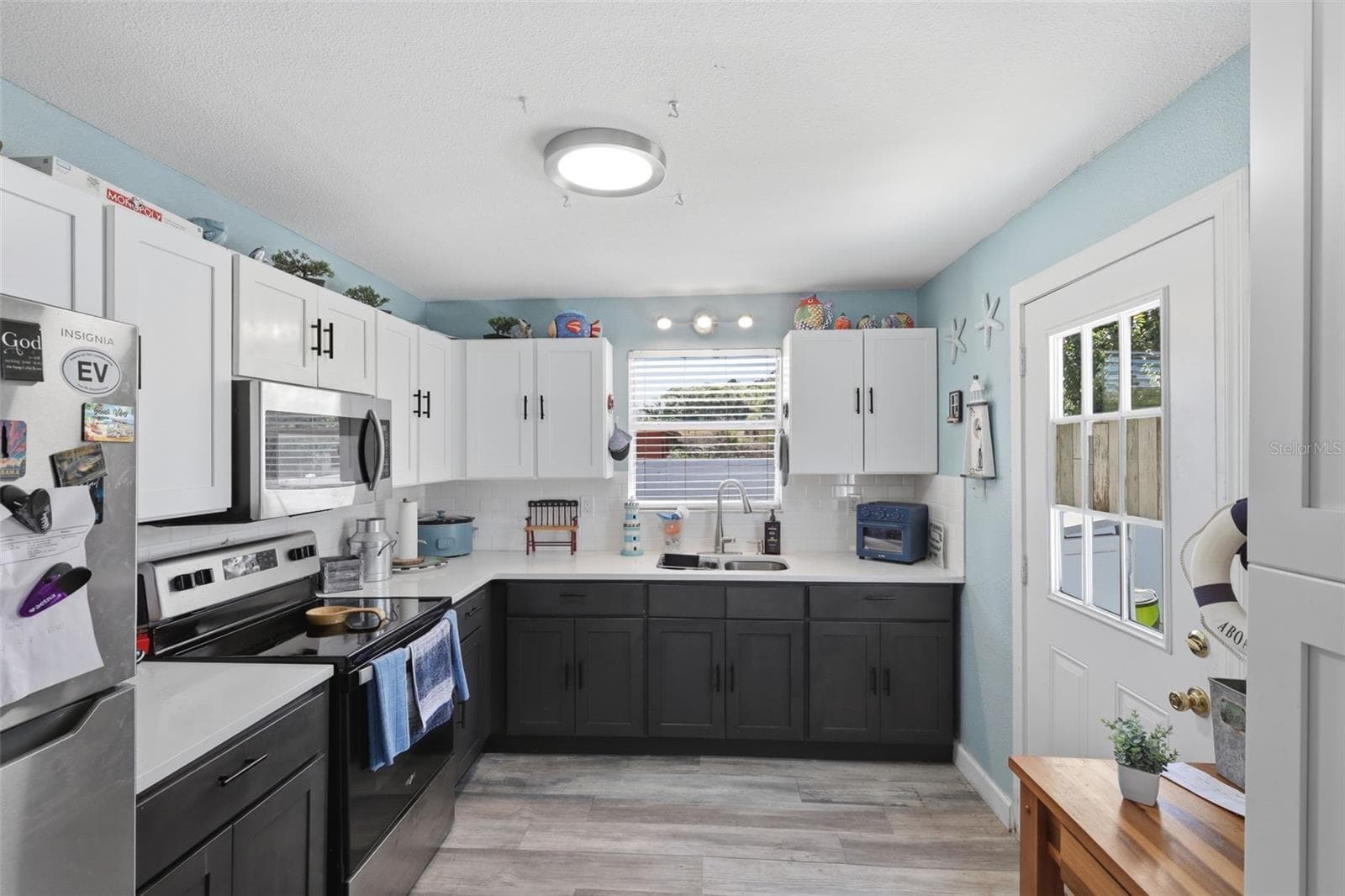 View of entire kitchen with stainless steal appliances. - 2559 HARRY T MOORE AVE, MIMS