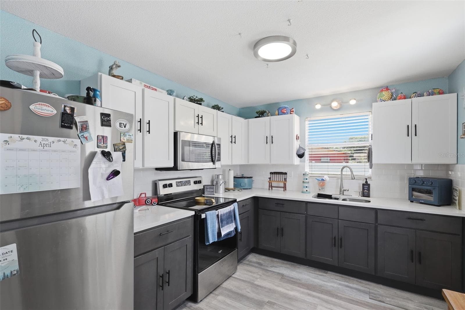 View of kitchen with plenty of cabinets, laminated florring. - 2559 HARRY T MOORE AVE, MIMS