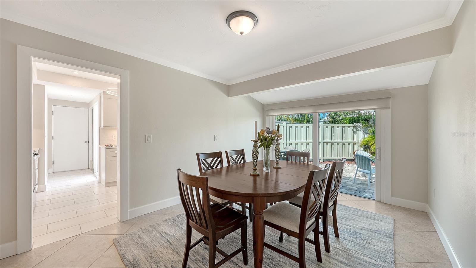 Dining room with floor to ceiling sliders opening to the private patio. - 206 HOURGLASS WAY #V10, SARASOTA
