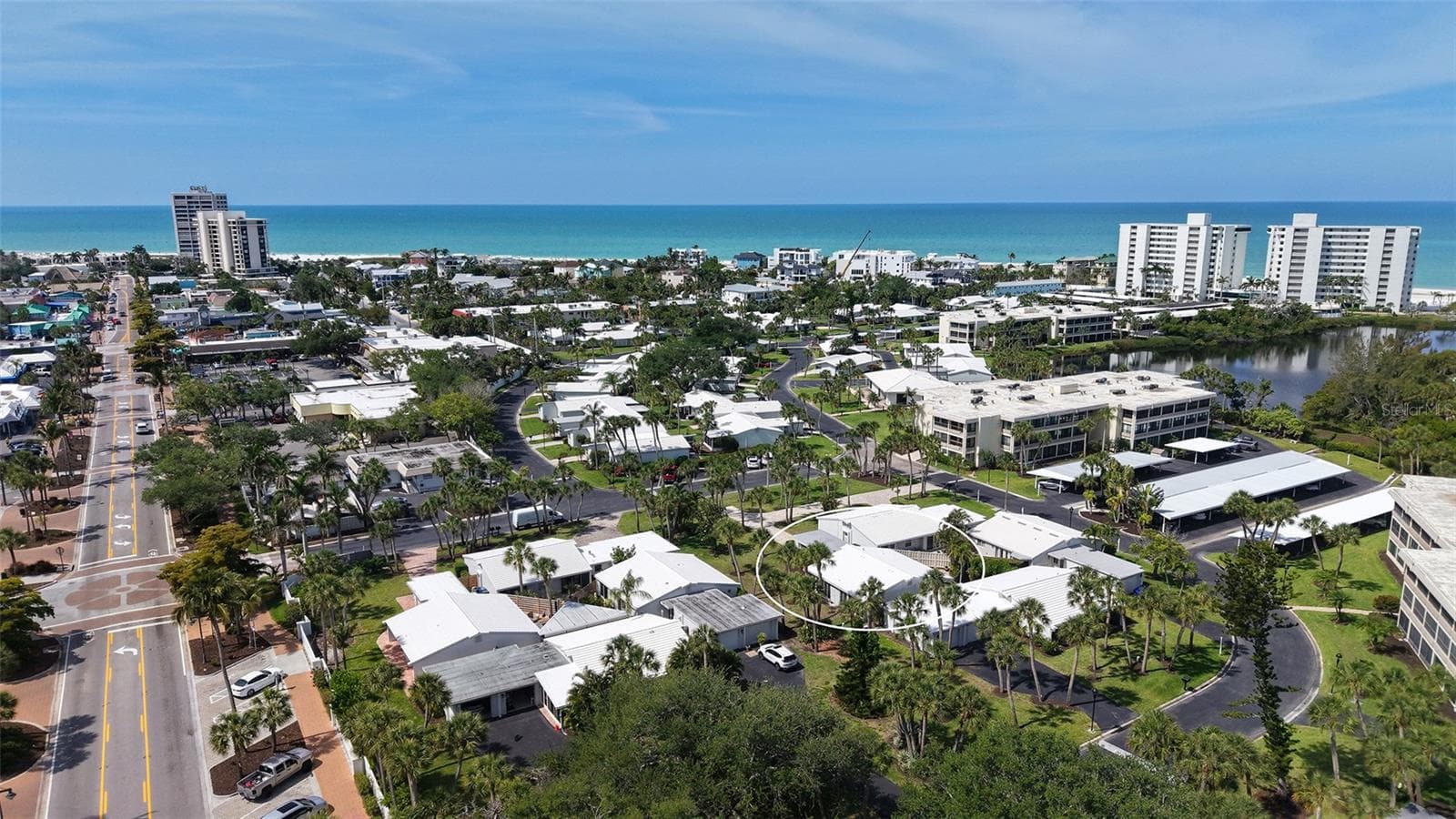Aerial view of Whispering Sands and Ocean Blvd leading west into Siesta Key Village. - 206 HOURGLASS WAY #V10, SARASOTA