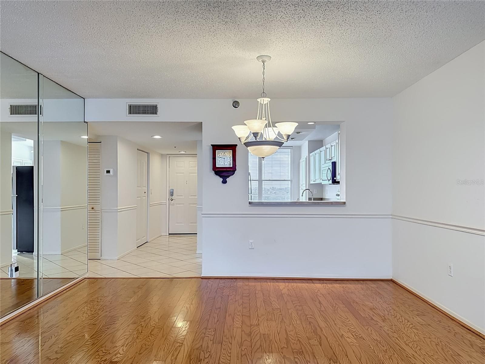 Dining room with pass-through to kitchen. - 3740 PINEBROOK CIR #607, BRADENTON