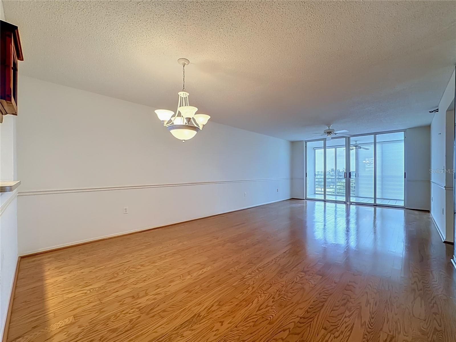 Full length view of the dining and living room combination. Slidig door leads to the bigger of two enclosed lanais. - 3740 PINEBROOK CIR #607, BRADENTON