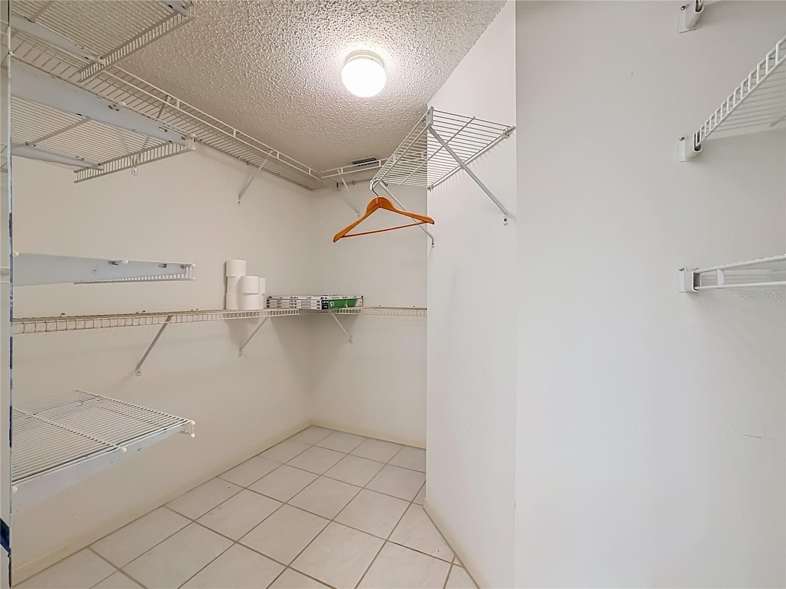 Large walk-in closet in the primary bedroom. - 3740 PINEBROOK CIR #607, BRADENTON