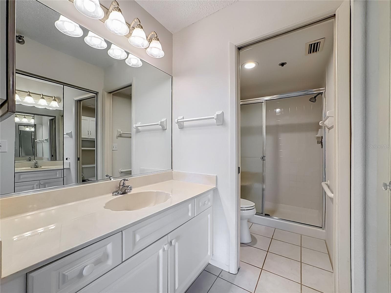 Primary bathroom with a pocket door for the toilet and shower. - 3740 PINEBROOK CIR #607, BRADENTON