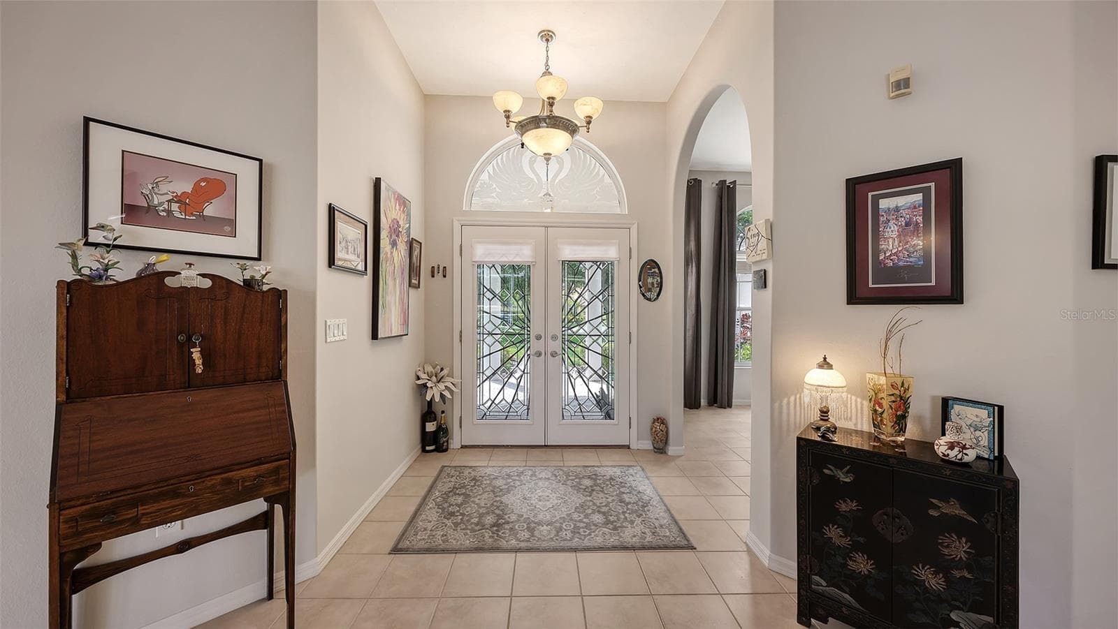 The Formal Entry leads to a large Living Room, Dining Room, & Den - 7025 N SERENOA DR, SARASOTA