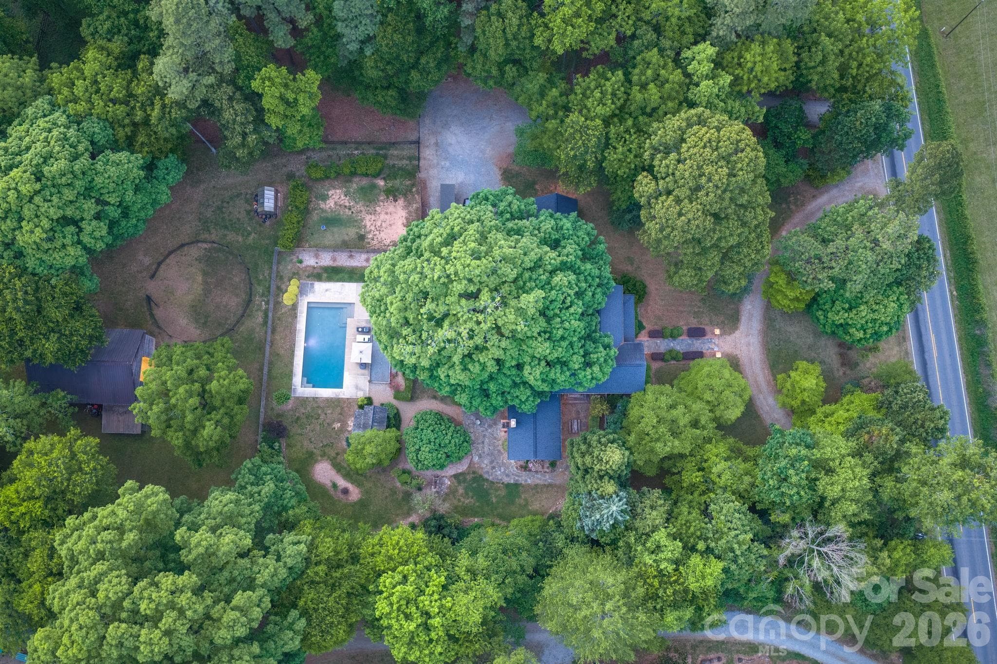 The tree canopy and landscaping provide a cool and private retreat around the home. - Huntersville