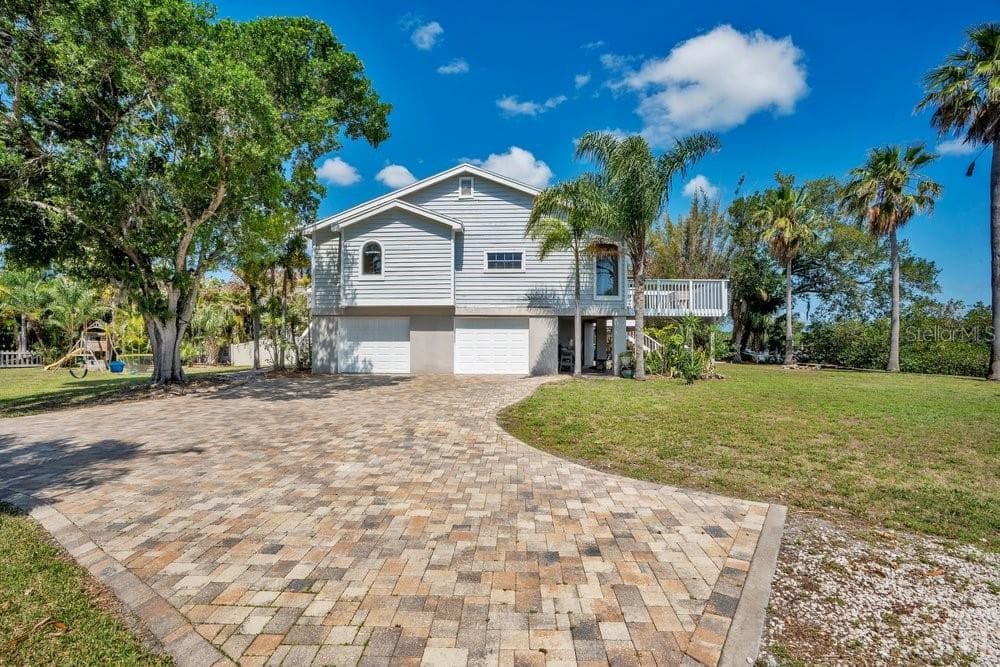 Elevated living space stayed dry during recent storms, paver driveway allows for plenty of parking and yard has room for pool and extra space for boats or RVs - 3858 SHORE BLVD, OLDSMAR