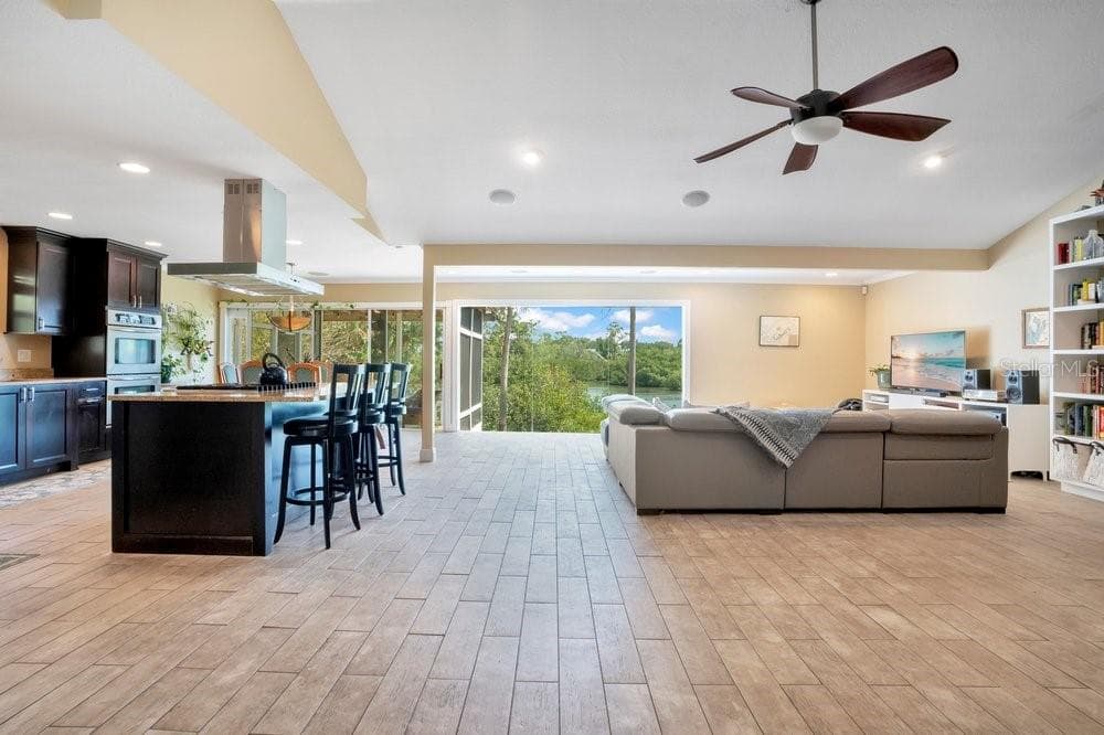 Open kitchen/living area with vaulted ceilings and an abundance of natural light - 3858 SHORE BLVD, OLDSMAR