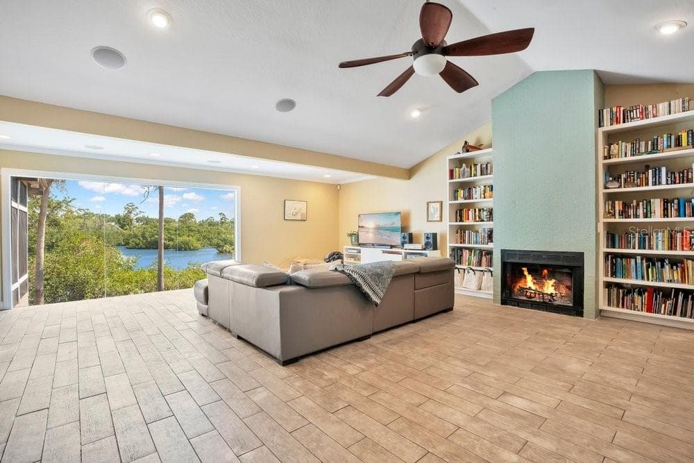 Wood burning fireplace adds to the ambiance, what a view! - 3858 SHORE BLVD, OLDSMAR