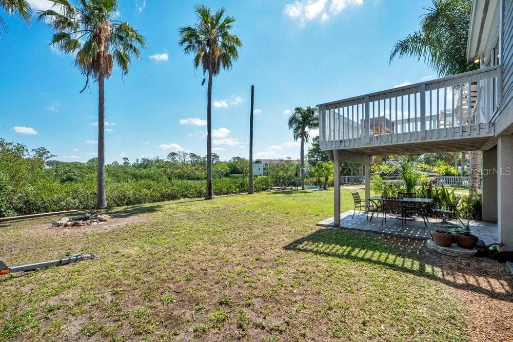 Fire pit and yard to canal to Tampa Bay - 3858 SHORE BLVD, OLDSMAR