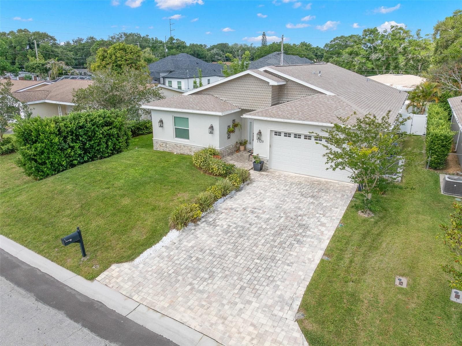 Neutral exterior tones, dimensional rooflines, and upgraded finishes create standout curb appeal just minutes from Countryside, Dunedin, and Gulf beaches. - 1720 VERDE DR, CLEARWATER