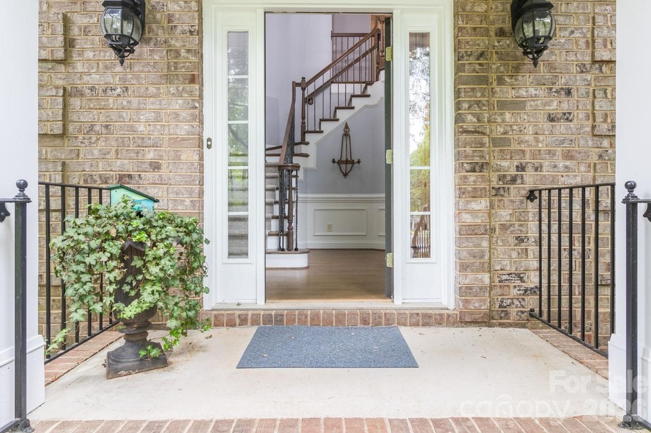 Enter into foyer featuring staircase with hand wrought iron spindles. - 4415 Everclear Court, Charlotte