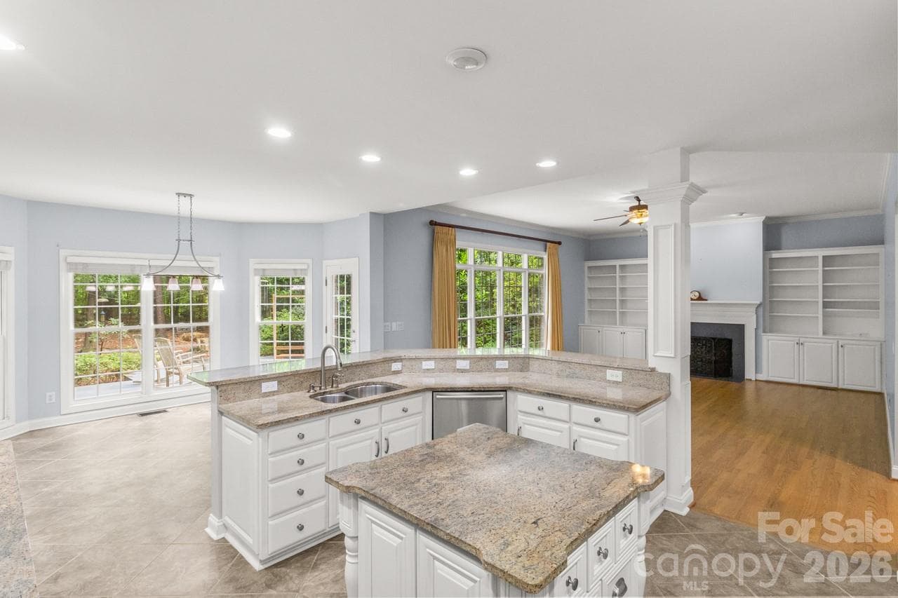 Updated kitchen with granite island is open to the breakfast area and family room. - 4415 Everclear Court, Charlotte