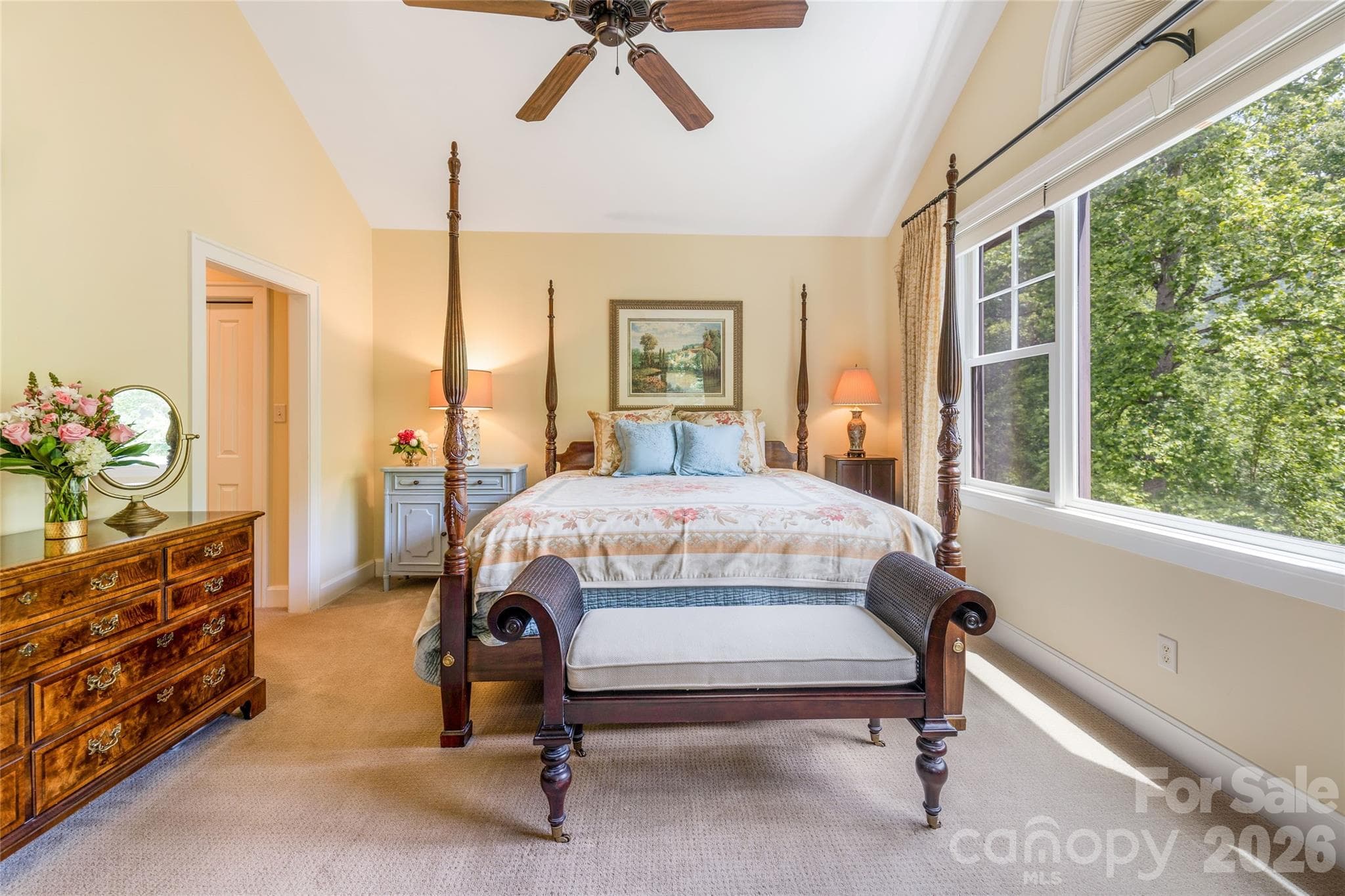 The primary bedroom features a large picture window, tall ceilings, double closets, and an ensuite. - 50 Meadow Village Lane, Asheville
