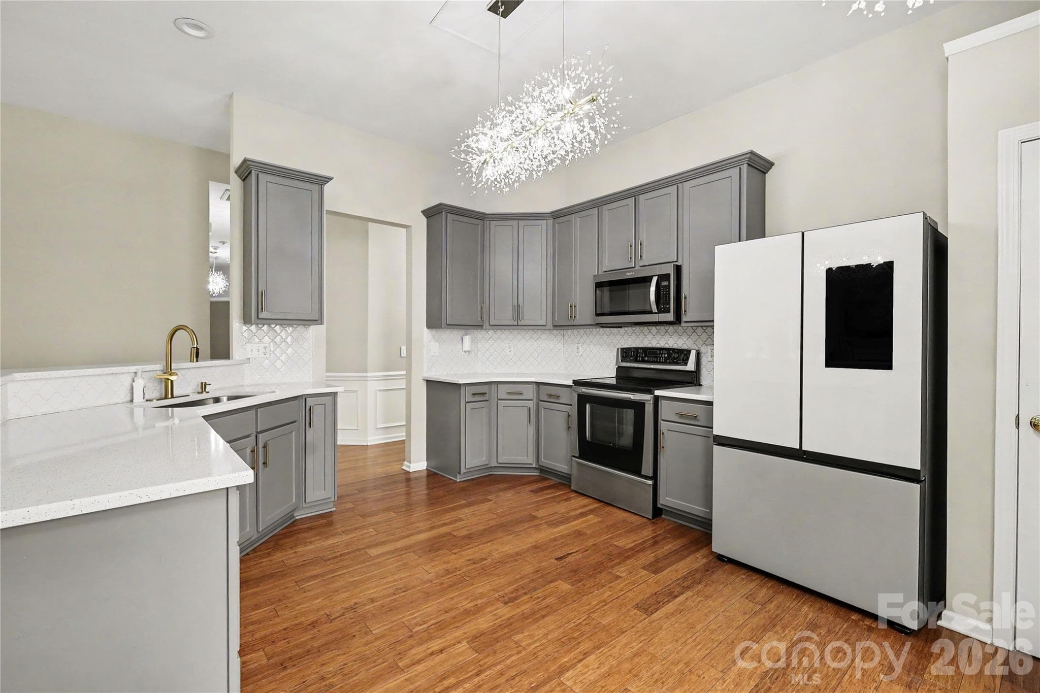 Kitchen with white quartz countertops and stainless steel appliances - Charlotte