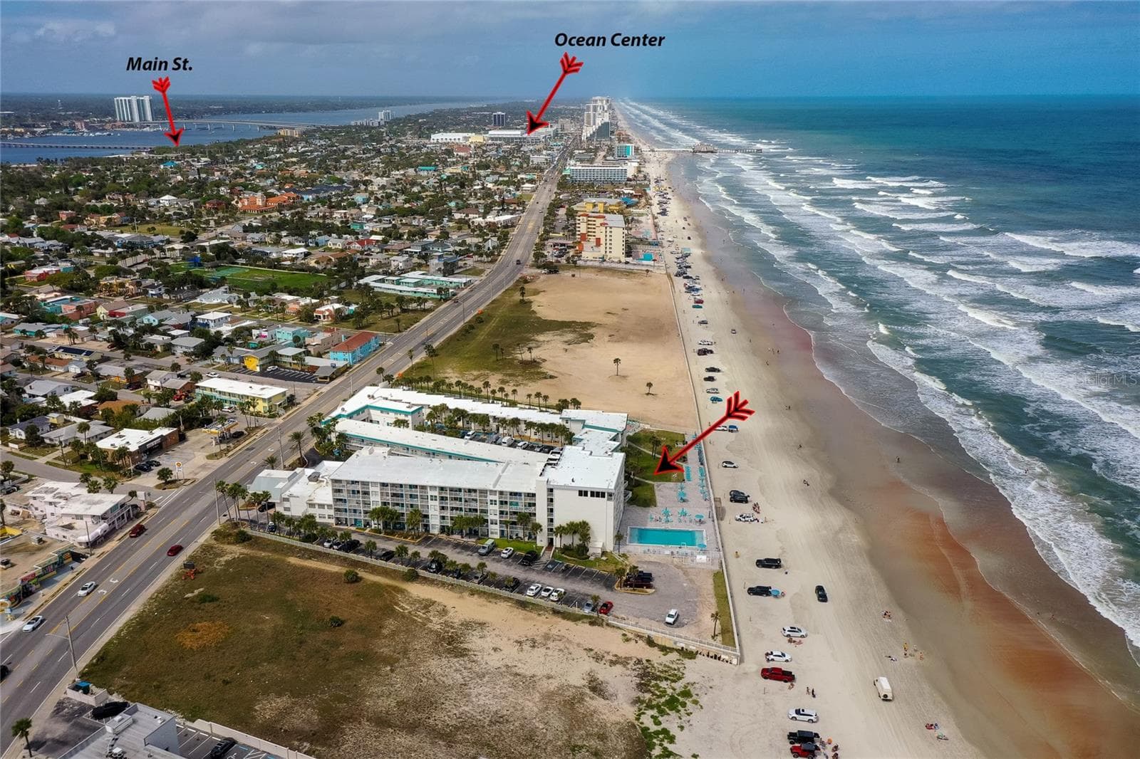 Aerial shot of the complex's recreational area, highlighting the large community pool, sun deck, and private beach access gate for residents and guests. - 935 S ATLANTIC AVE #165, DAYTONA BEACH