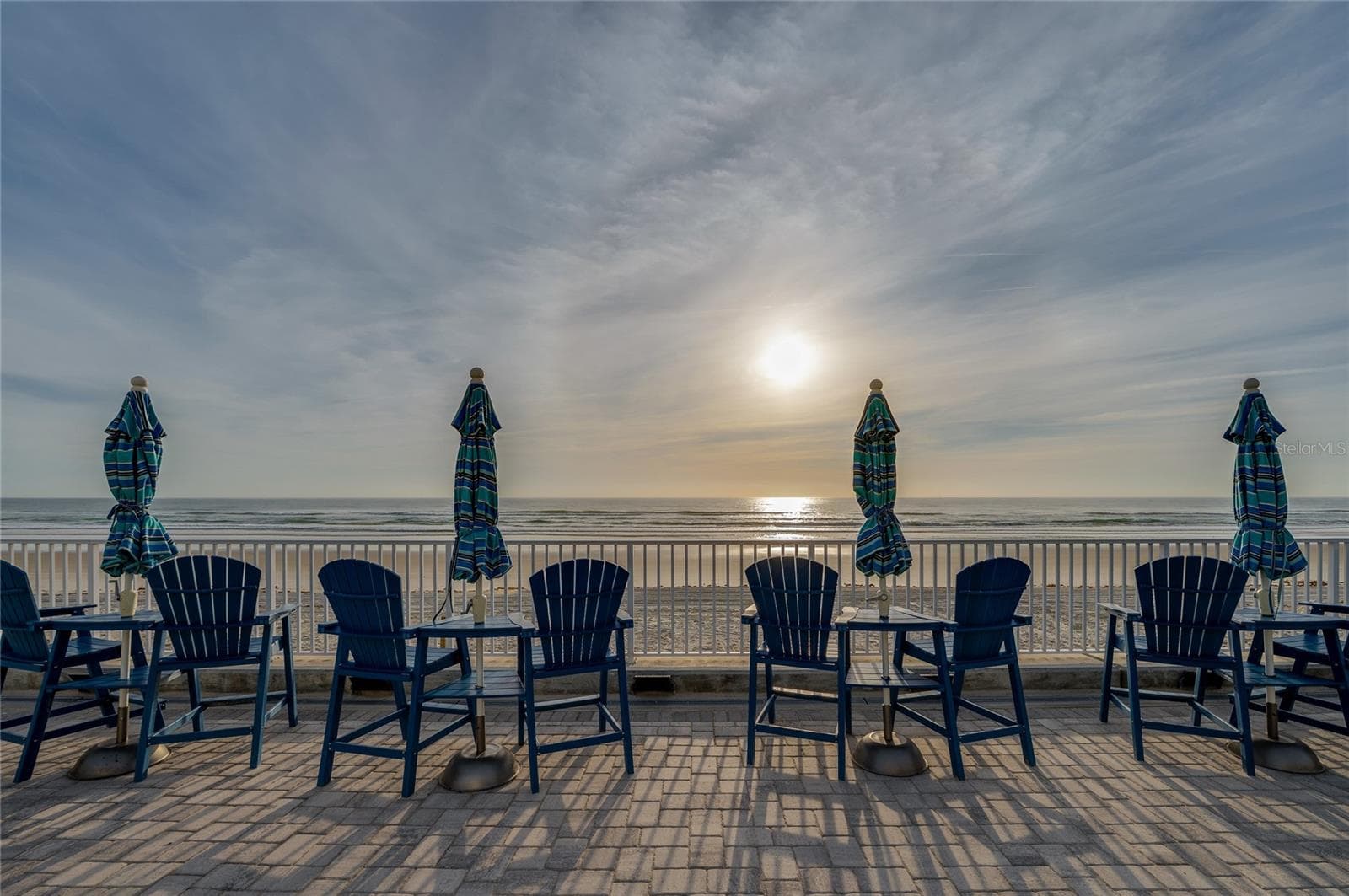 Coastal community layout highlighting the easy flow between the residential buildings, outdoor dining areas, and the direct beach access point. - 935 S ATLANTIC AVE #165, DAYTONA BEACH