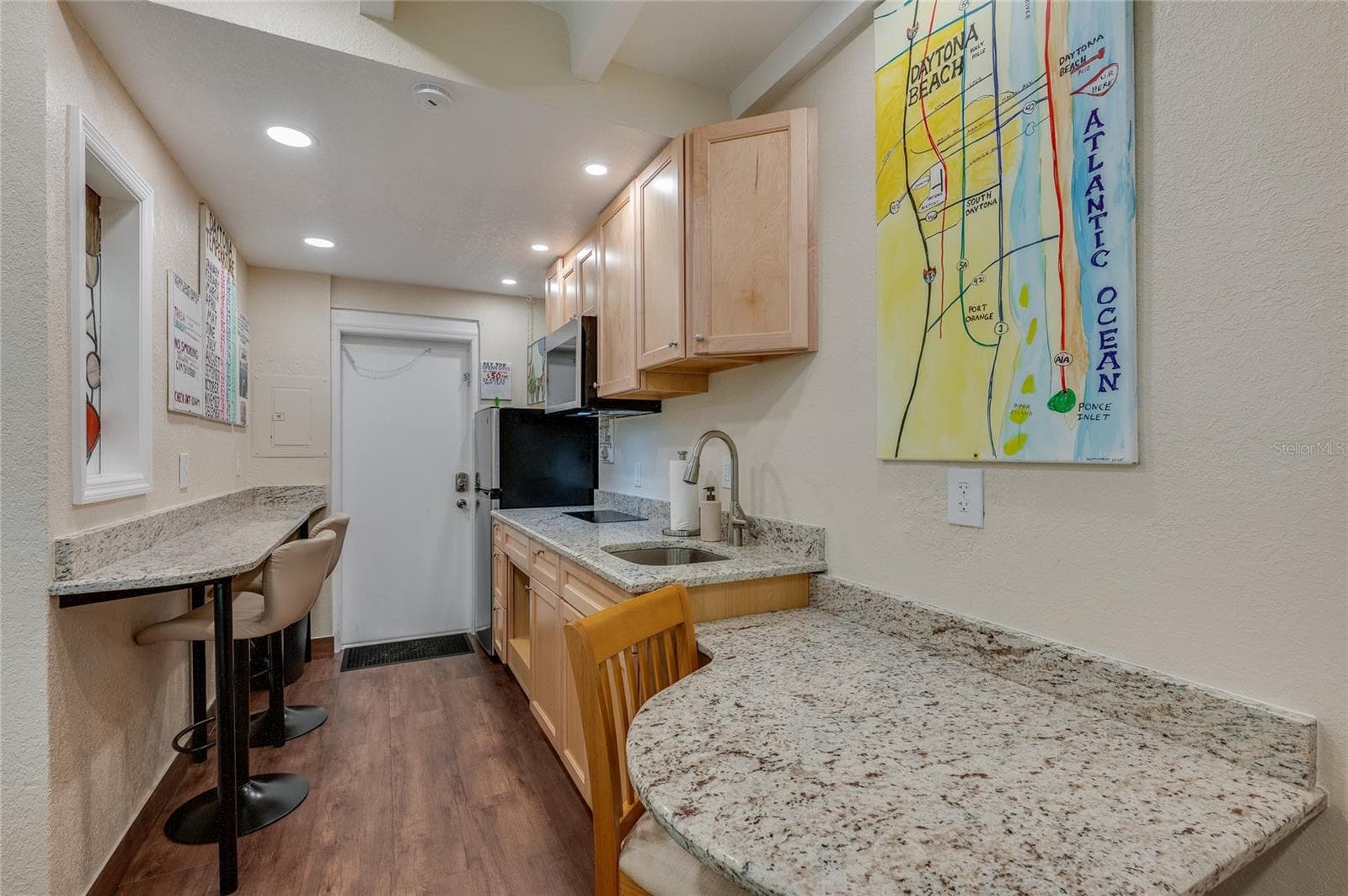 Compact and functional kitchen setup with ample counter space and essential appliances, perfect for preparing beachside snacks or full meals. - 935 S ATLANTIC AVE #165, DAYTONA BEACH