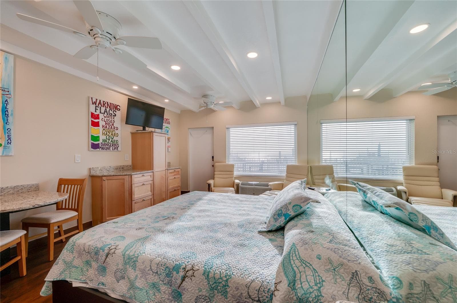 Inviting sleeping area tucked into the studio's "easy-flow" floor plan, creating a restful atmosphere without sacrificing the open feel of the unit. - 935 S ATLANTIC AVE #165, DAYTONA BEACH