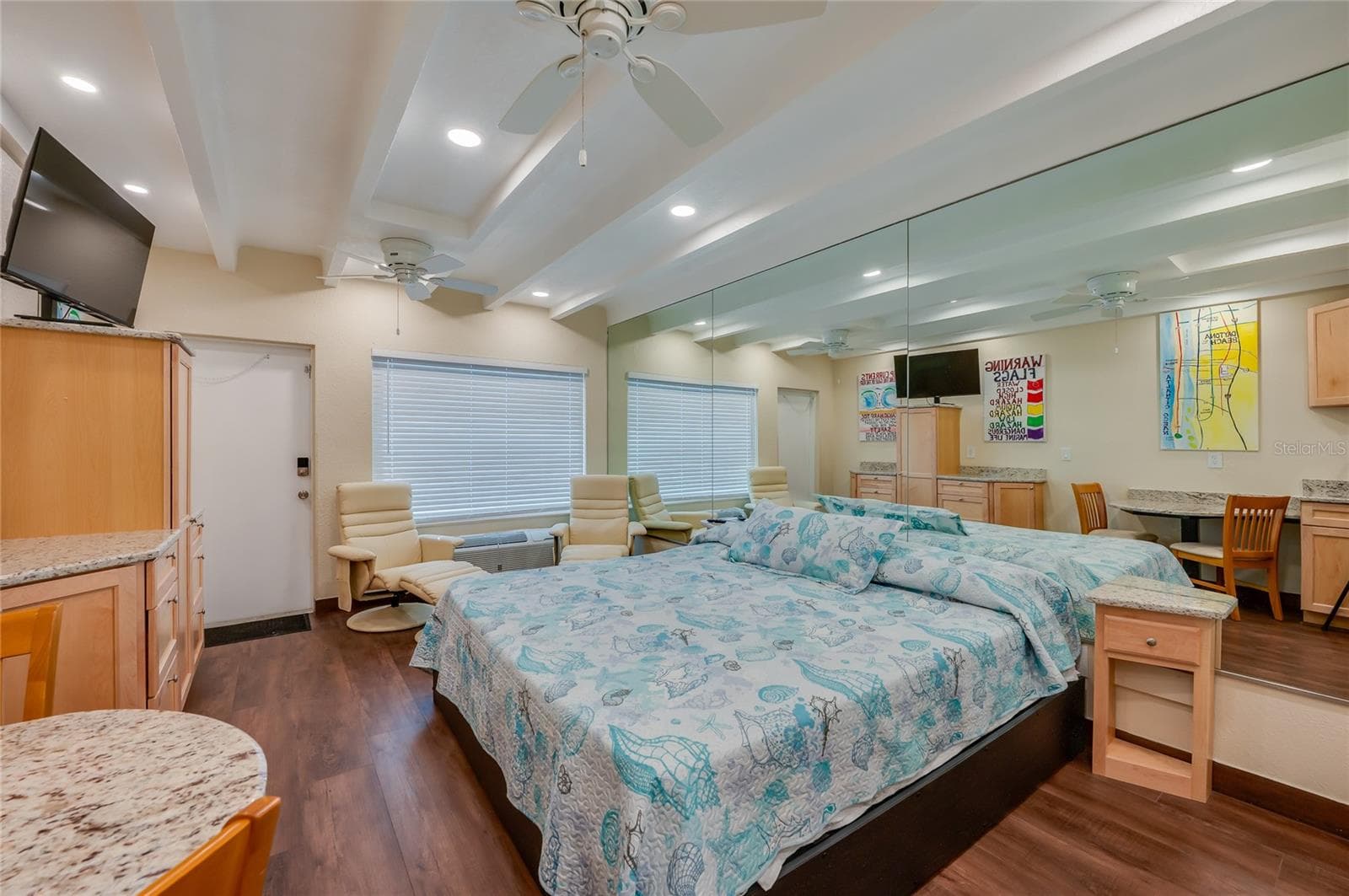 Alternative view of the main living space, highlighting the versatile furniture arrangement and the bright, airy feel of the interior. - 935 S ATLANTIC AVE #165, DAYTONA BEACH