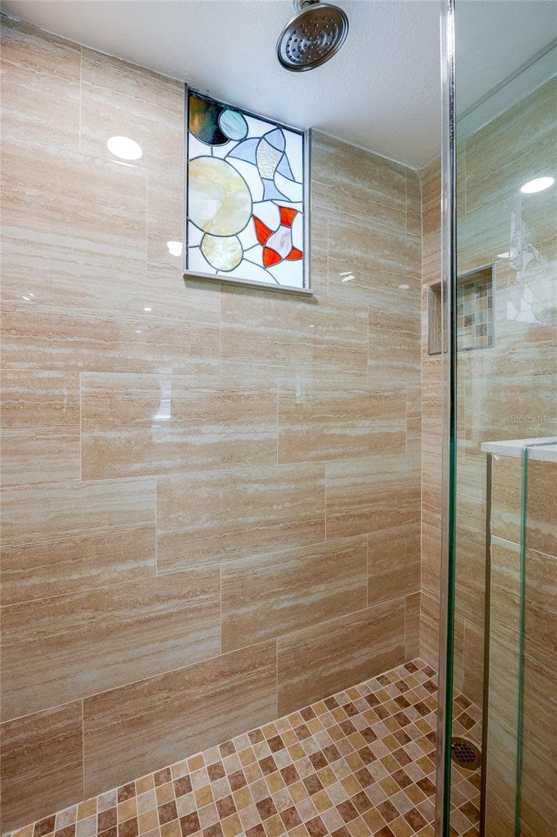 Functional bathroom with bright lighting, providing a crisp and clean space for guests to freshen up. - 935 S ATLANTIC AVE #165, DAYTONA BEACH