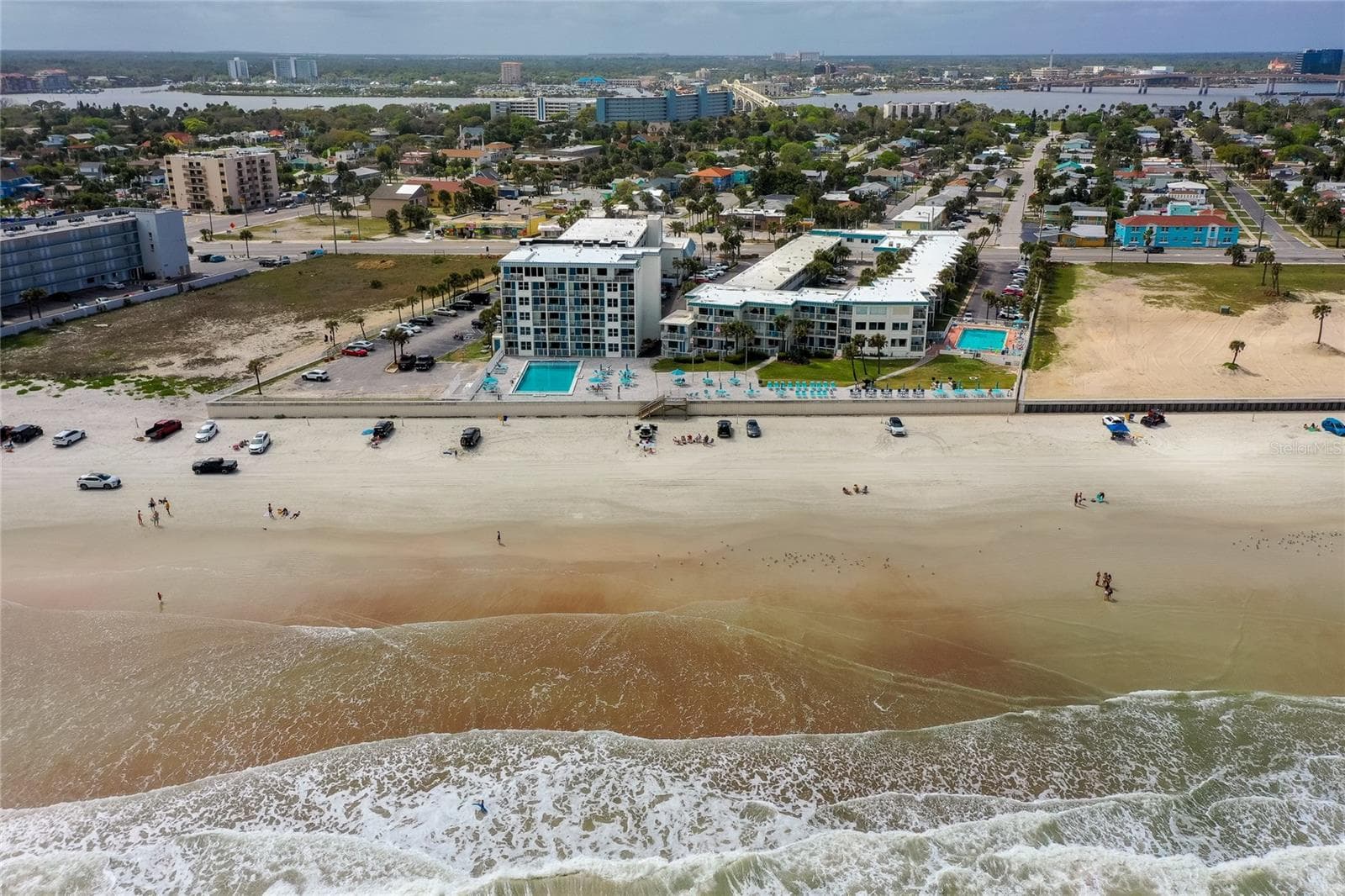 Stunning bird's-eye view of the resort grounds, featuring the sparkling blue pool as the centerpiece and the direct, unobstructed access to the Ocean. - 935 S ATLANTIC AVE #165, DAYTONA BEACH