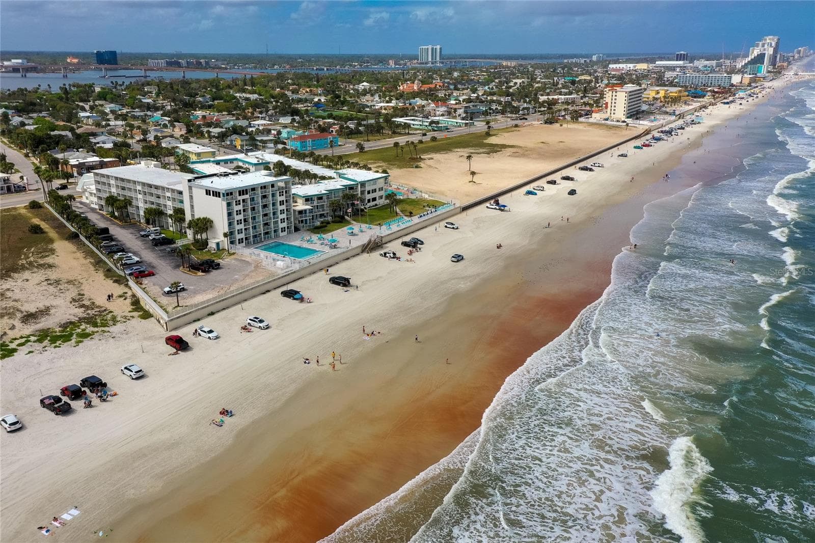 Aerial view looking along the coastline, showcasing the vibrant blue waters and the endless horizon—a visual testament to the incredible views available from the property. - 935 S ATLANTIC AVE #165, DAYTONA BEACH