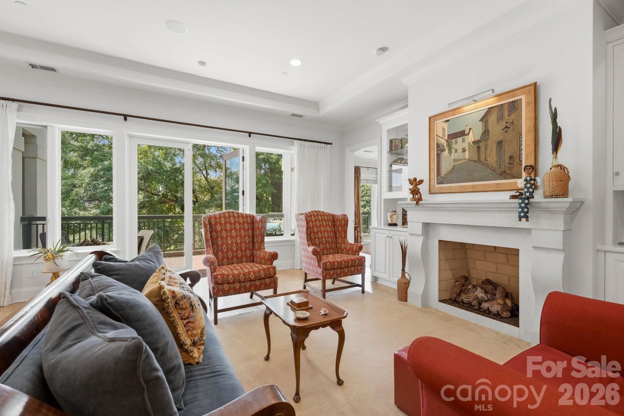 Bright and inviting living area with oversized windows, beautiful natural light, and seamless access to the private covered terrace overlooking Fourth Ward. - Charlotte