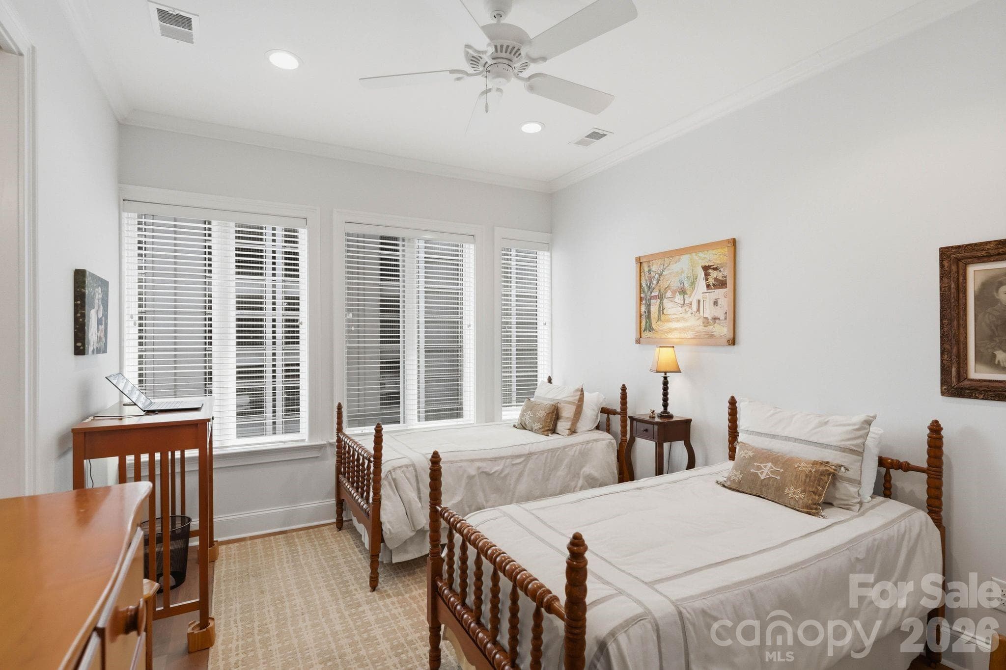 Bright secondary bedroom with large windows, hardwood flooring, and flexible space ideal for guests, a home office, or additional living needs. - Charlotte