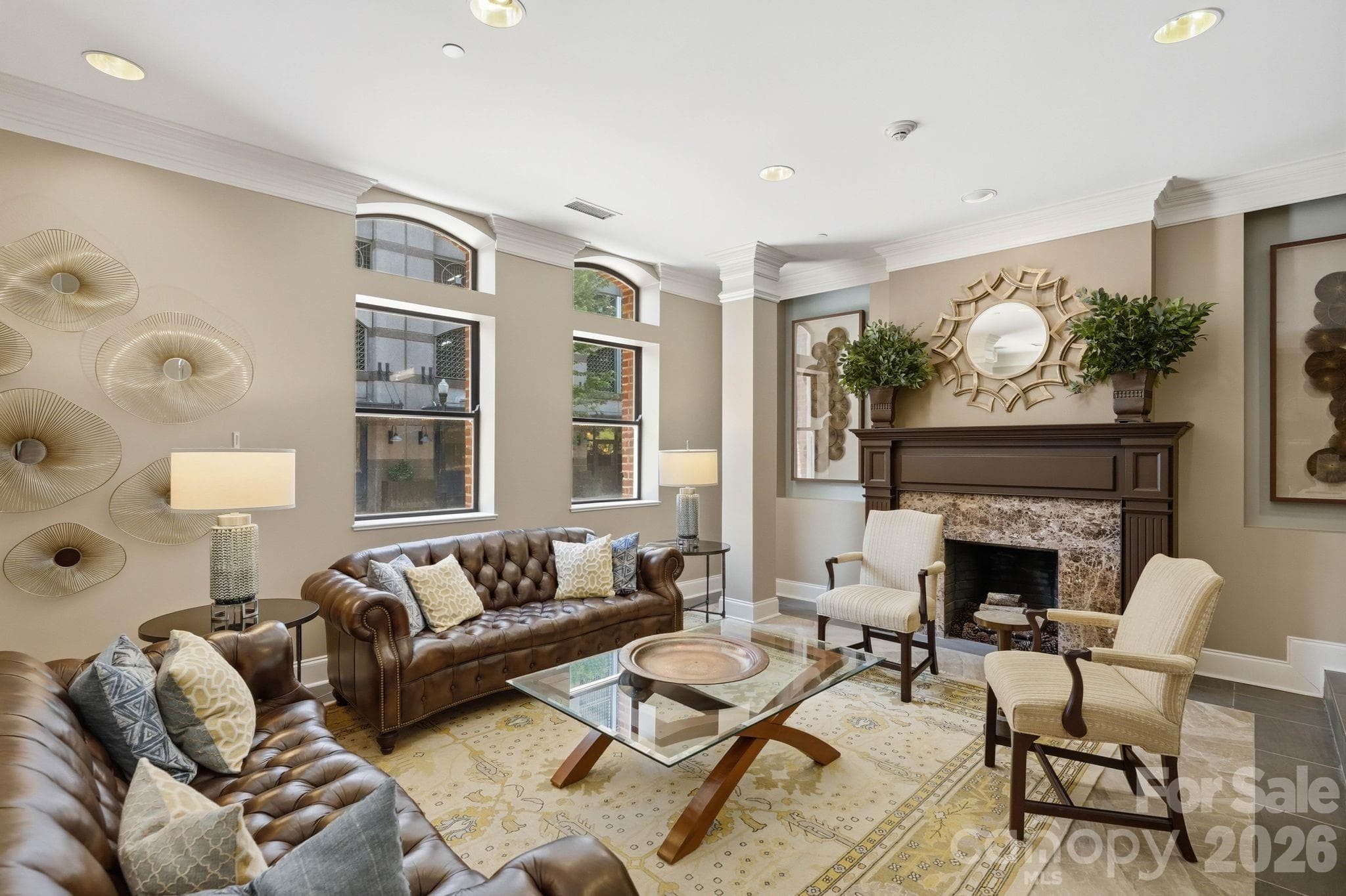 Elegant resident lobby with sophisticated seating areas, fireplace, and timeless design details that create a warm and welcoming first impression. - Charlotte