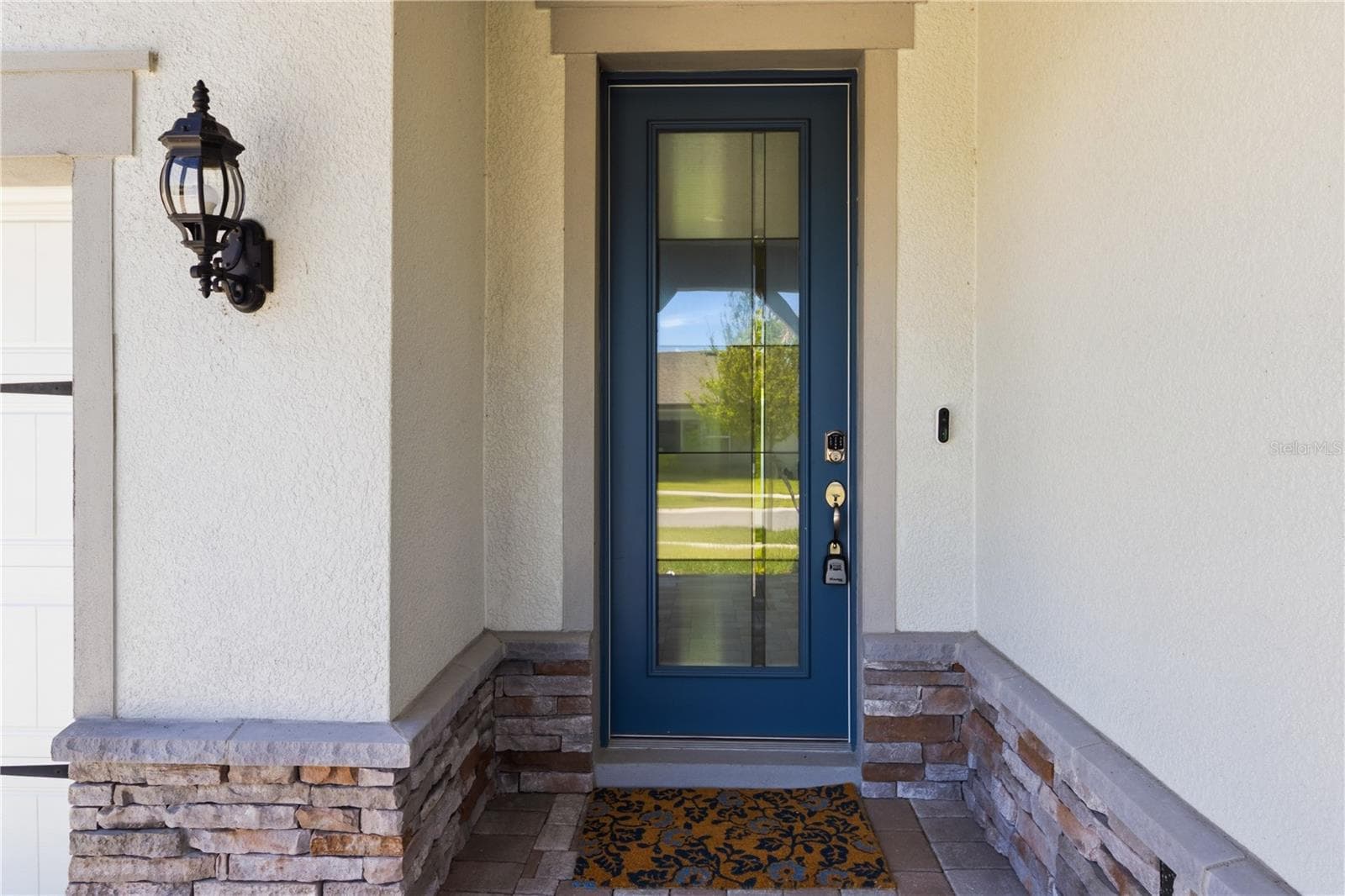 Covered front entry creates a warm first impression before stepping inside. - 13824 SUNLIGHT MEADOW DR, RIVERVIEW