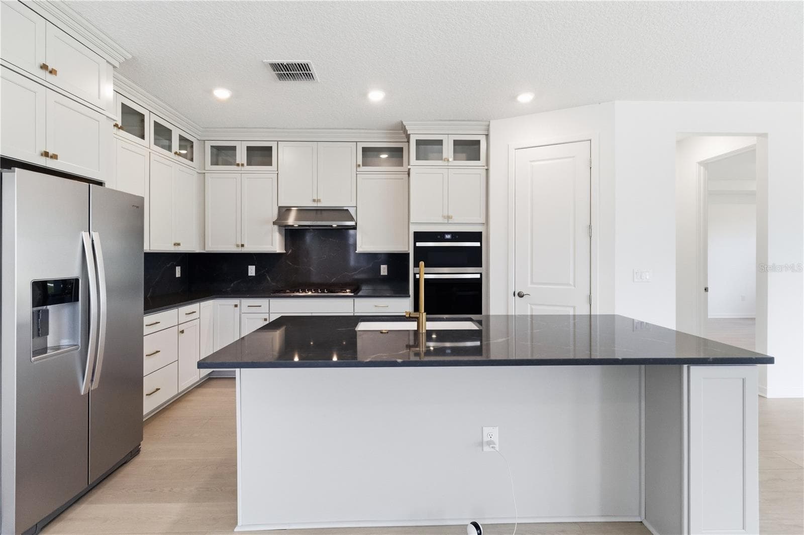 Open kitchen and gathering space designed for meals, conversation, and connection. - 13824 SUNLIGHT MEADOW DR, RIVERVIEW