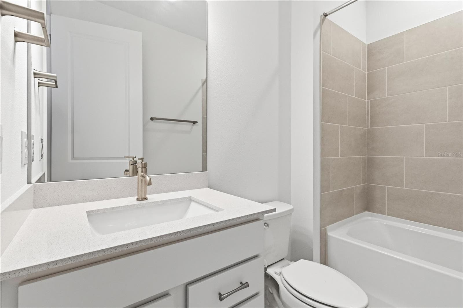 Fresh bathroom with upgraded finishes, bright cabinetry, and a tub/ shower. - 13824 SUNLIGHT MEADOW DR, RIVERVIEW