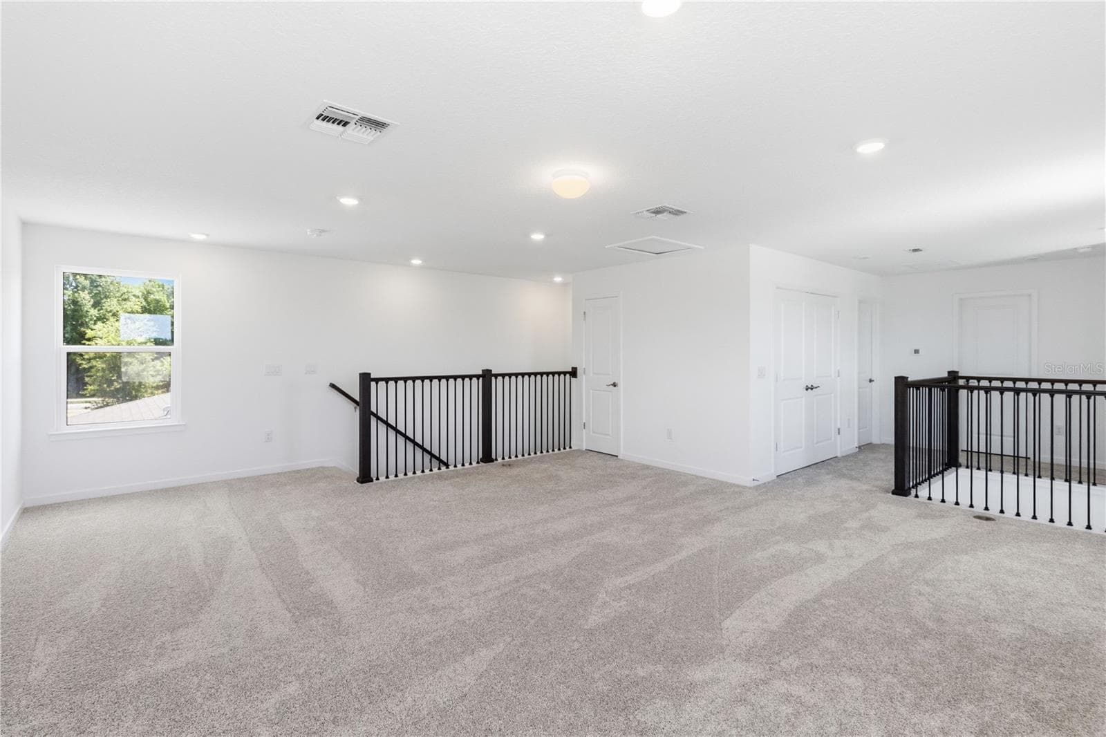 Large upstairs loft with open sightlines and flexible space for a second living area. - 13824 SUNLIGHT MEADOW DR, RIVERVIEW